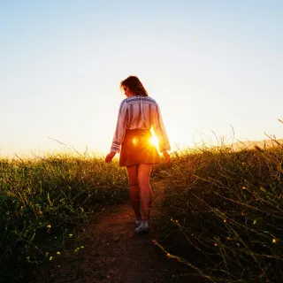 Mujer caminando al atardecer